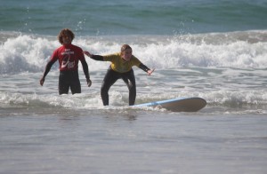 Khalid giving a lessons to a new surfer in the white water